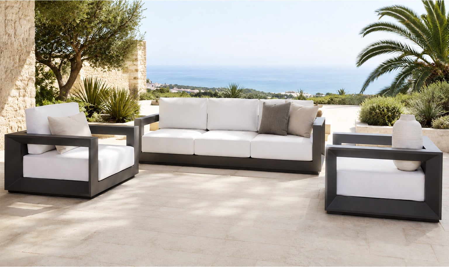 Modern outdoor sectional sofa with light grey cushions and a wood-top coffee table in a covered terrace setting